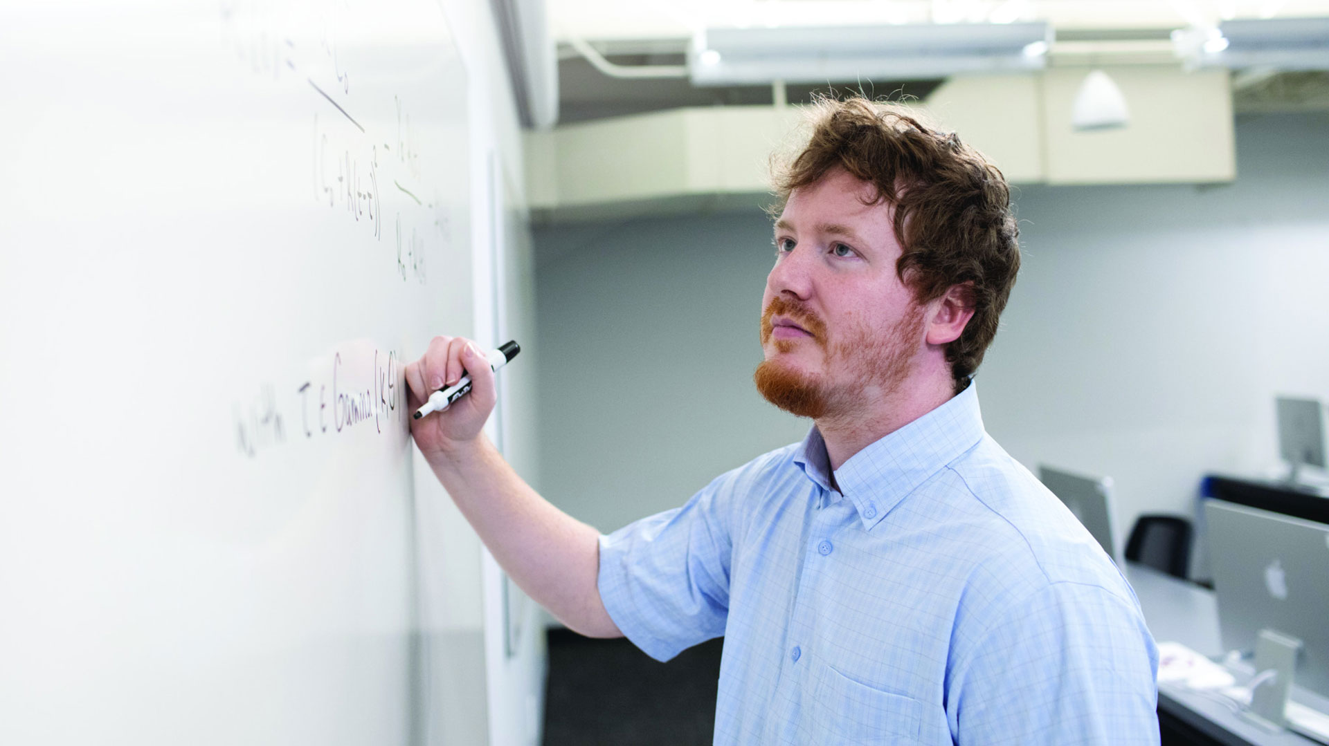 Kenneth  Evans writing on white board