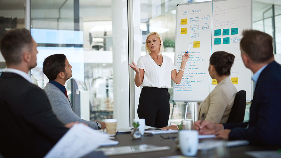 A group of people around a conference table for a presentation